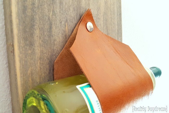 Wall-mounted wine rack... using leather as the slings! {Reality Daydream}