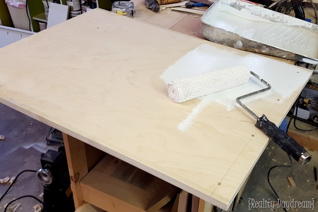 Prime the rolling kitchen island before painting.