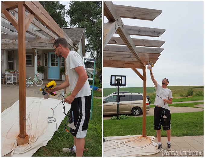 Using a sprayer makes staining the pergola a breeze!