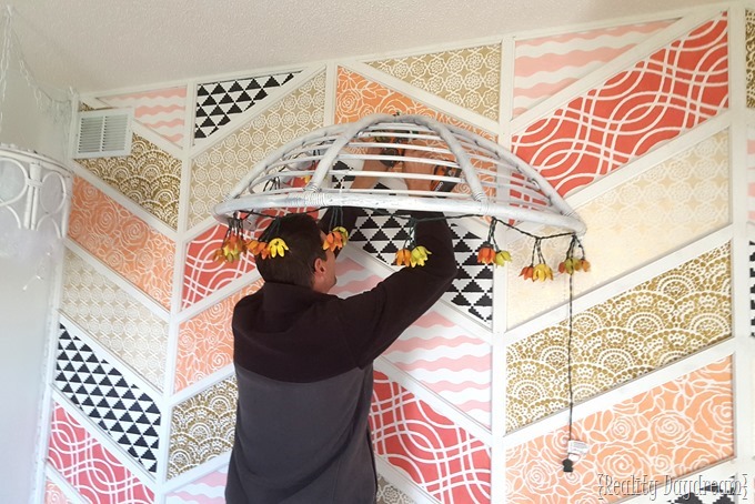 Use an old Papasan Chair Frame (cut in half) to make a canopy for a reading nook OR above a little girls bed! {Reality Daydream}